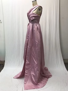 Close-up of pink satin evening gown featuring waist lace trim and high side slit detail