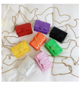 Flat lay of colorful mini heart crossbody bags with V-shaped quilting and gold chains