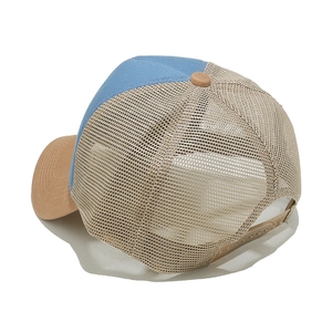 Detail view of breathable trucker hat with light blue panel and khaki mesh backing