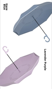 Detail of reverse umbrellas in blue and purple with C-shaped hands-free handles