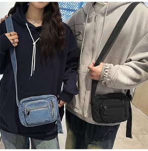 Detail view of denim and canvas crossbody bags showing zipper layers and adjustable straps