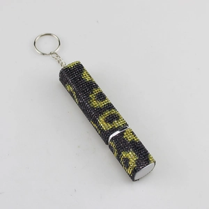 Detail of refillable perfume bottle with leopard print rhinestones and silver keychain