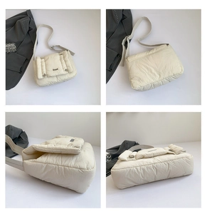 Detailweergave van de crème gewatteerde crossbodytas met puffy textuur en gesp