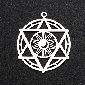 Macro view of silver stainless steel hexagram and moon pendant with hollow geometry