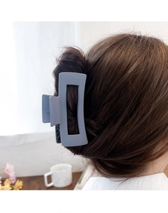 Close-up of Morandi blue matte rectangular hollow hair claw clip in long hair