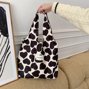 Detail of corduroy heart print tote bag featuring Love Sozakka label in a home setting