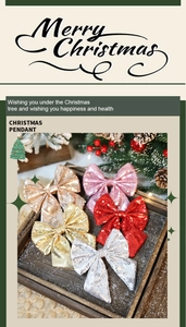 Glitter fabric Christmas bow pendants in red, gold, and silver on a festive tray