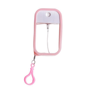Close-up of pink 50ml card spray bottle with matching keychain hook on white background