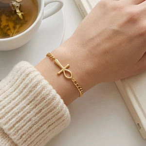 Elegant gold Ankh cross bracelet for women with minimalist Egyptian charm on a model's wrist