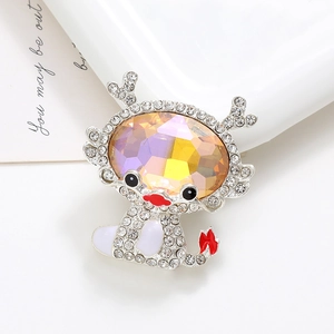 Macro shot of rhinestone-encrusted dragon charm with a large multi-faceted iridescent gem