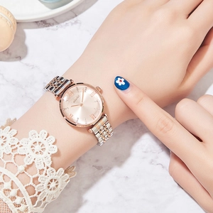 Close-up of a two-tone rose gold and silver stainless steel women watch on marble