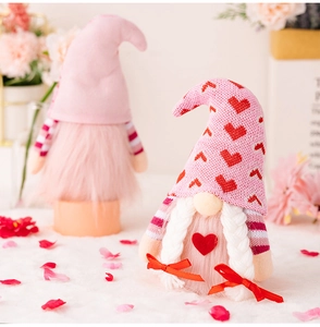 Detail view of Valentine's gnome pair with heart patterns and pink plush beards