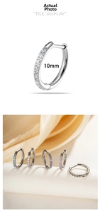 Detail of 10mm titanium hoop earrings with micro-set multi-color zircon stones