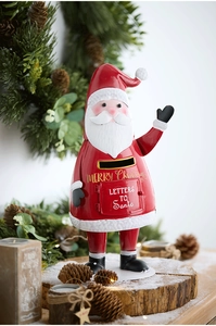 Detailed view of red metal Santa mailbox ornament with Merry Christmas gold lettering