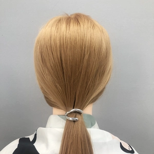 Minimalist silver alloy twisted hair clip shown on low ponytail hairstyle for women