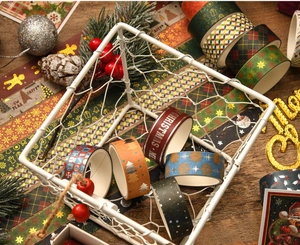 Detailed view of Christmas washi tapes with gold foil snowflakes and trees in a decor basket