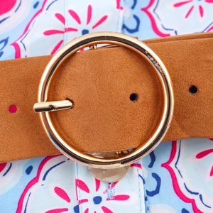 Brown suede belt with golden round buckle on a geometric V-neck shirt dress with waist tie