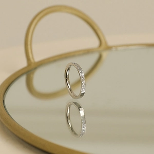 Elegant silver titanium steel ring with ten micro-pave crystals on a mirror tray