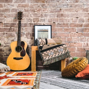 Detail of bohemian geometric woven blanket with fringe edge in a rustic interior