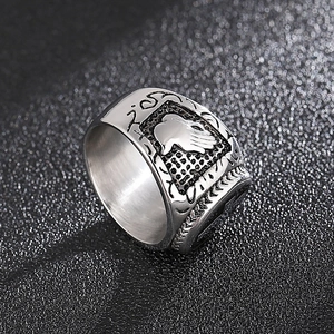 Macro shot of silver stainless steel ring with vintage hand crest and textured pattern