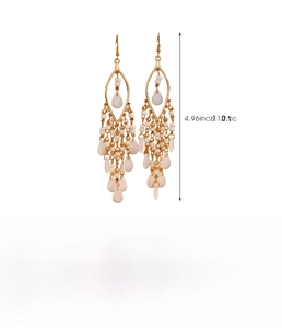 Detail view of Bohemian long tassel earrings with gold zinc alloy and white beaded drops