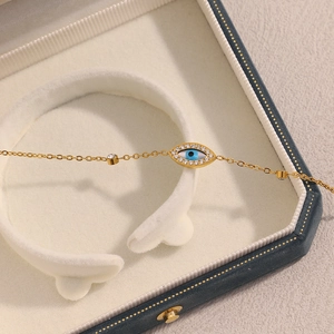Detail of 18K gold-plated evil eye bracelet with blue center and sparkling crystals