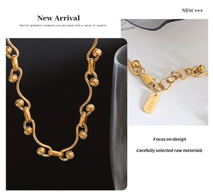 Macro detail of gold chunky link chain with lobster clasp and Lucky engraved tag
