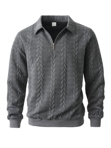 Detail view of jacquard and cable knit texture on dark grey half-zip pullover sweater