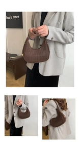 Detail view of brown quilted felt hobo bag with gold hardware and shoulder strap