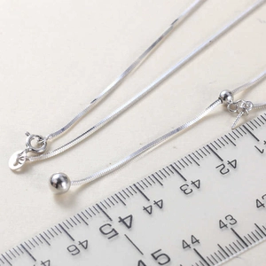 Macro shot of S925 sterling silver snake chain showing spring clasp and length scale