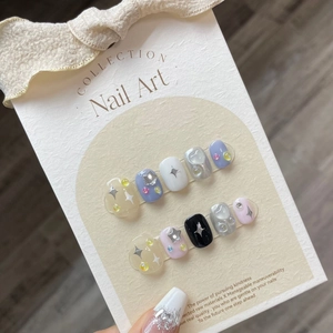 Ice cream blue and yellow press-on nails with star patterns and sparkling rhinestone details