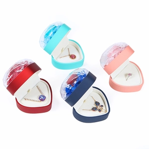 Heart-shaped eternal rose jewelry gift boxes in red, pink, and blue with necklaces