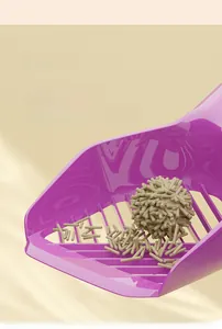 Macro view of a purple cat litter shovel with large slats filtering tofu litter pellets