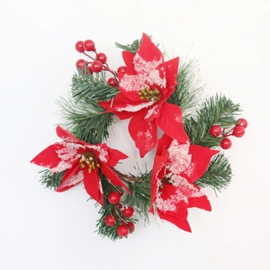 Christmas candle ring with red poinsettia flowers, berries and snowy cedar needles