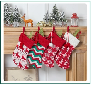 Knitted Christmas stockings with reindeer and snowflake patterns hanging on a wooden mantel