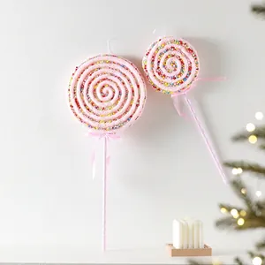 Pink knit Christmas lollipop ornaments with colorful beads and festive ribbon decoration