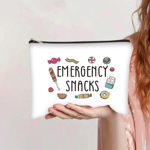 Detail of canvas toiletry bag with zipper and colorful Emergency Snacks print