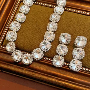 Elegant silver jewelry set with round crystal pendant necklace and matching drop earrings