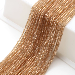 Macro shot of faceted champagne crystal beads on white stand for DIY jewelry making