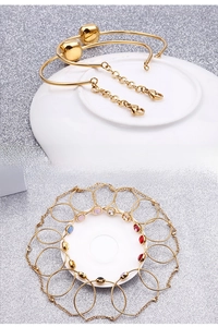 Detailed view of 18k gold plated bracelets with charms and colorful zircon stones