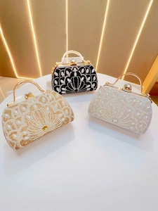 Three elegant evening bags in black, gold, and white with peacock feather rhinestone patterns