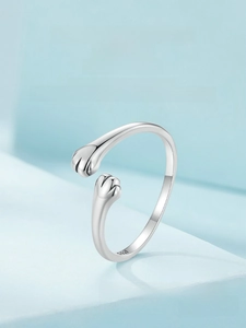 Macro shot of S925 sterling silver cat paw embrace ring with polished metal finish