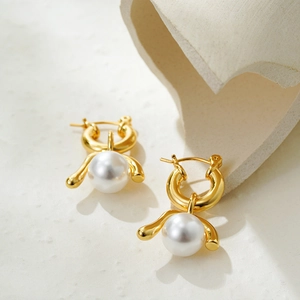 Macro view of gold pearl earrings with a large white pearl in a vintage setting