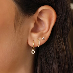Close-up of gold S925 silver earring set with turquoise and zircon on a female model