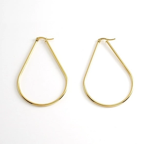 Macro shot of minimalist gold teardrop hoop earrings with high-polish mirror finish