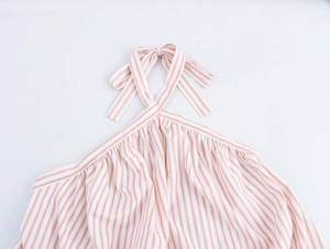 Detail of orange striped halter neck top with pleated neckline and elegant back bow tie