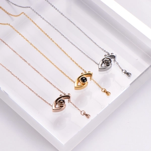 Minimalist evil eye projection necklace in gold, silver, and rose gold finishes