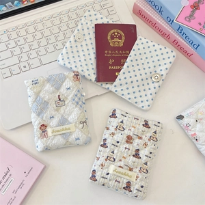 Close-up of quilted cotton passport holders with cute animal patterns and card slots