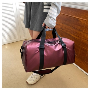 Close-up of purple waterproof travel bag with glossy finish and reinforced straps