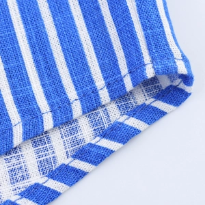 Detailed macro view of the blue and white striped linen fabric and high-quality stitching